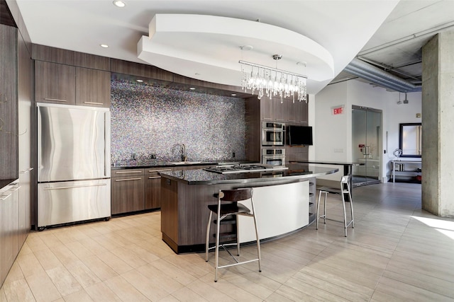 1901 Post Oak Blvd Unit 609, Houston, TX 77056 - kitchen with stainless steel appliances, dark countertops, a kitchen breakfast bar, modern cabinets, and backsplash