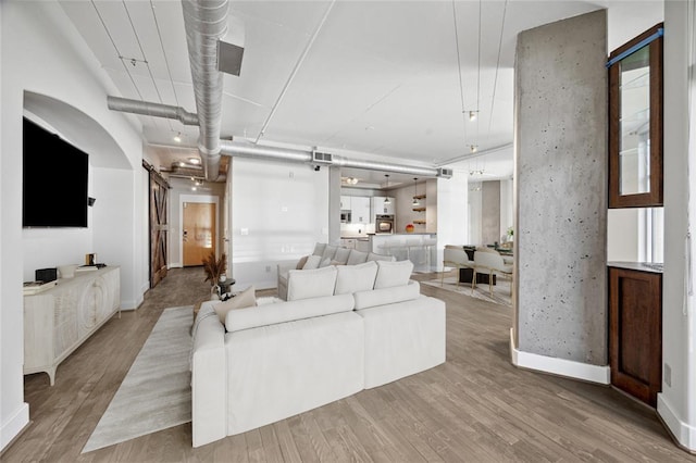 1901 Post Oak Blvd Unit 609, Houston, TX 77056 - living room featuring light wood-style floors and baseboards
