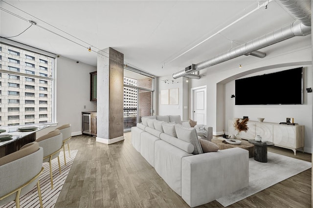 1901 Post Oak Blvd Unit 609, Houston, TX 77056 - living room featuring wood finished floors and healthy amount of natural light