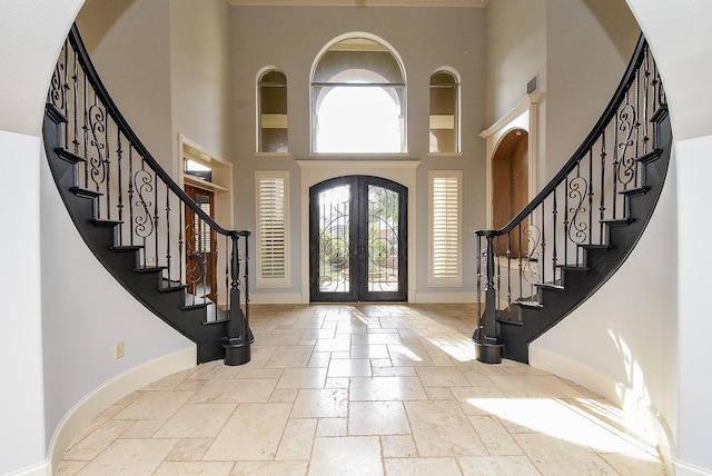 42 Lake Sterling Gate Dr, Spring, TX 77379 - entryway with a high ceiling, stone tile flooring, stairway, and french doors