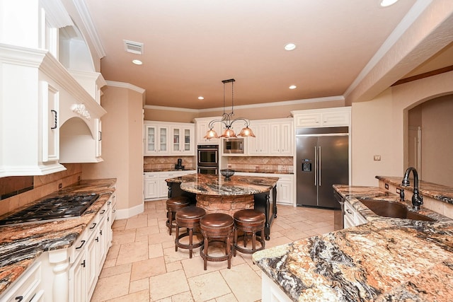 42 Lake Sterling Gate Dr, Spring, TX 77379 - kitchen featuring built in appliances, a center island, recessed lighting, backsplash, and a breakfast bar