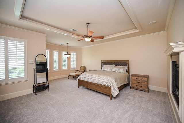 42 Lake Sterling Gate Dr, Spring, TX 77379 - bedroom with a raised ceiling, ornamental molding, light carpet, and a fireplace