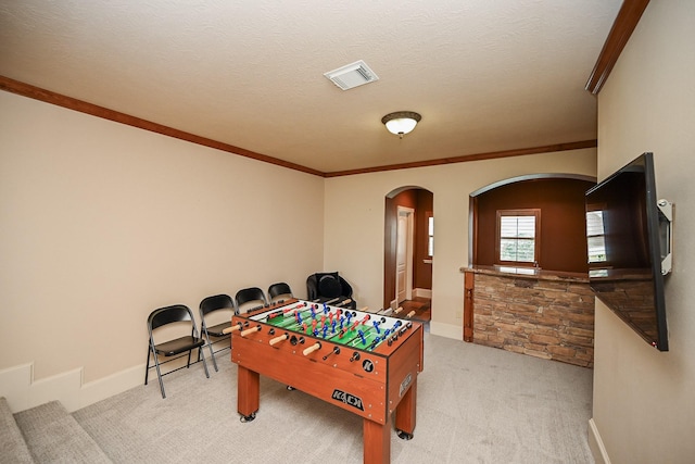 42 Lake Sterling Gate Dr, Spring, TX 77379 - rec room with arched walkways, light colored carpet, and ornamental molding