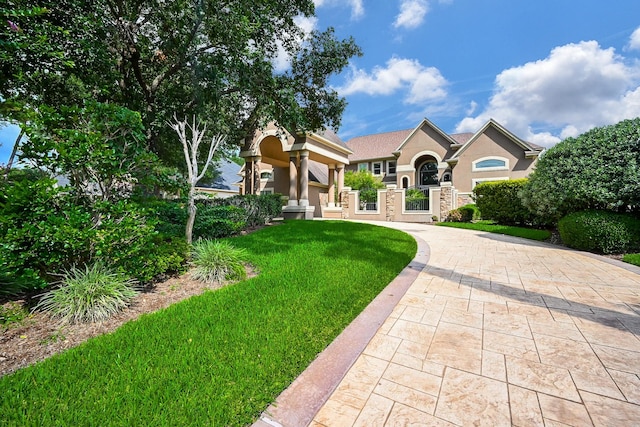 42 Lake Sterling Gate Dr, Spring, TX 77379 - view of front of property with stucco siding, a front yard, driveway, and a gate