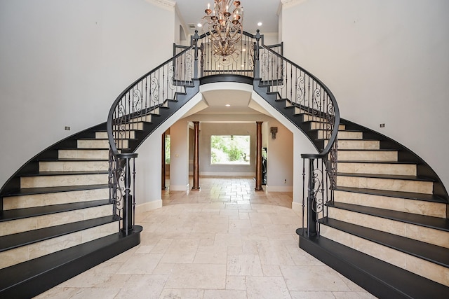 42 Lake Sterling Gate Dr, Spring, TX 77379 - foyer with stone tile flooring, stairs, a high ceiling, a chandelier, and arched walkways