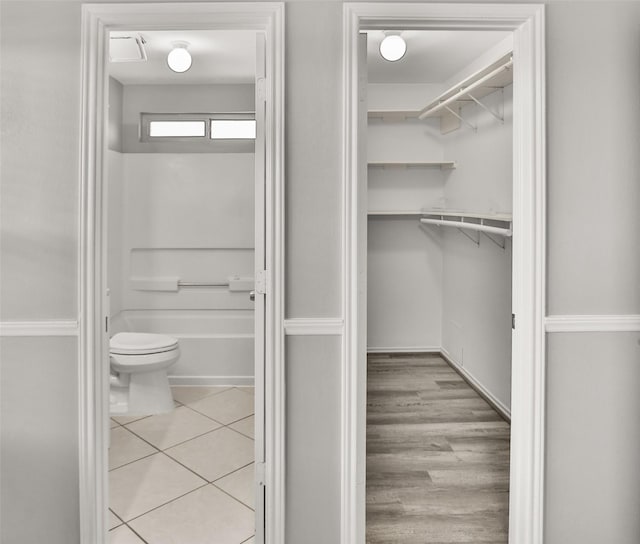 3445 Van Ness Dr, Alvin, TX 77511 - bathroom featuring a bathtub, a walk in closet, and tile patterned flooring