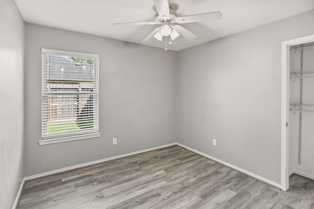 3445 Van Ness Dr, Alvin, TX 77511 - unfurnished bedroom featuring wood finished floors, ceiling fan, a spacious closet, and a closet