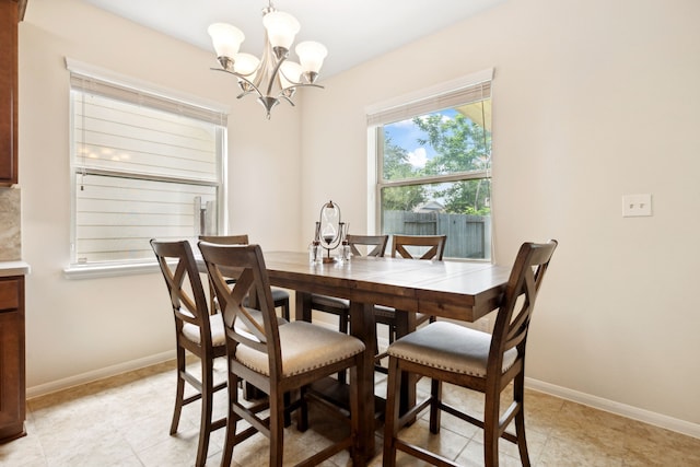 11134 Sun River Falls Dr, Humble, TX 77396 - dining area featuring a chandelier and light tile patterned floors