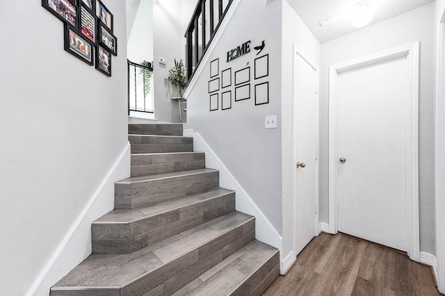 18446 N Willow Bluff Rd, Katy, TX 77449 - stairway featuring wood finished floors and baseboards
