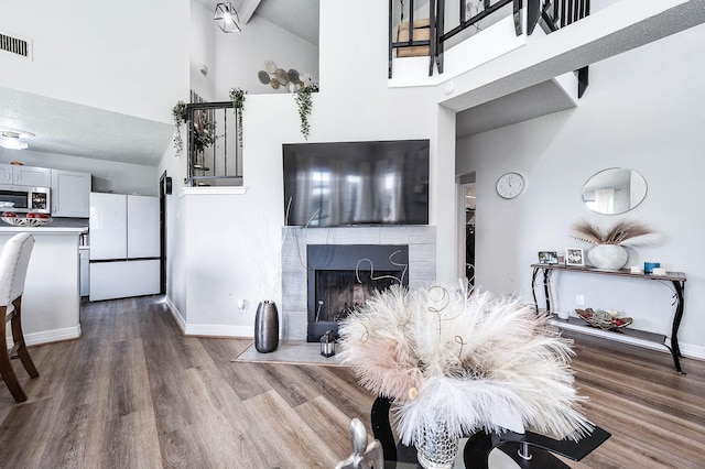 18446 N Willow Bluff Rd, Katy, TX 77449 - living area with high vaulted ceiling, wood finished floors, and a fireplace