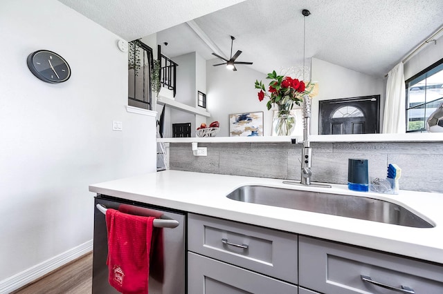 18446 N Willow Bluff Rd, Katy, TX 77449 - kitchen with gray cabinets, light countertops, a textured ceiling, a ceiling fan, and wood finished floors