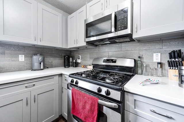 18446 N Willow Bluff Rd, Katy, TX 77449 - kitchen with stainless steel appliances, light countertops, tasteful backsplash, and a textured ceiling