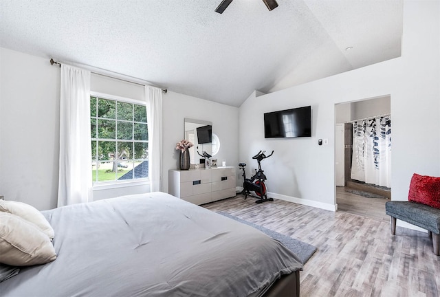 18446 N Willow Bluff Rd, Katy, TX 77449 - bedroom with wood finished floors, a textured ceiling, lofted ceiling, and ceiling fan
