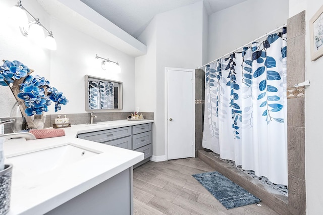 18446 N Willow Bluff Rd, Katy, TX 77449 - full bathroom featuring vanity, wood finished floors, and a shower with curtain