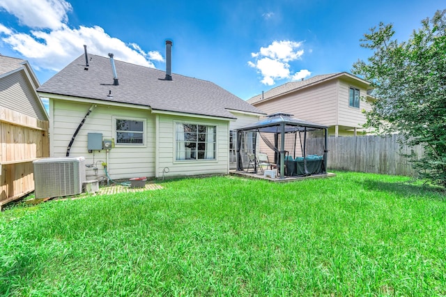 18446 N Willow Bluff Rd, Katy, TX 77449 - back of property with a gazebo, a fenced backyard, roof with shingles, and a patio