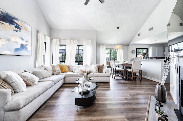 18446 N Willow Bluff Rd, Katy, TX 77449 - living room with dark wood finished floors, a textured ceiling, ceiling fan, and high vaulted ceiling