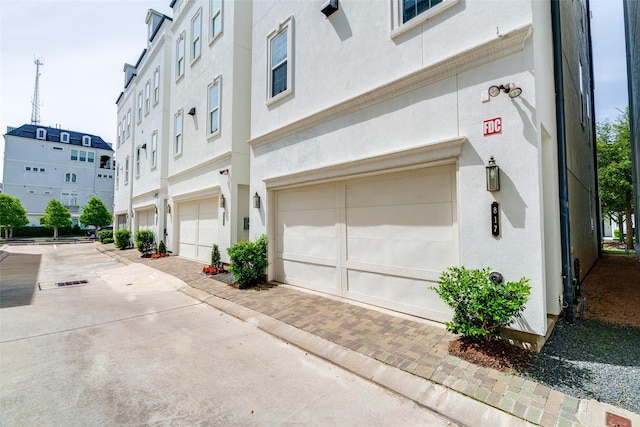 817 Blackshire Ln, Houston, TX 77055 - view of property featuring decorative driveway and an attached garage