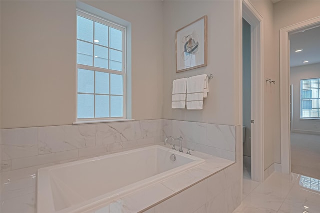 817 Blackshire Ln, Houston, TX 77055 - full bathroom featuring a garden tub and marble finish flooring