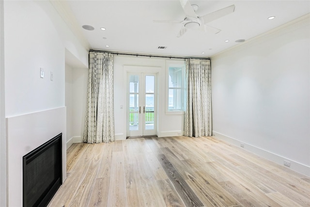 2425 E Seaside Dr, Galveston, TX 77550 - unfurnished living room featuring french doors, a glass covered fireplace, ceiling fan, light wood-type flooring, and ornamental molding