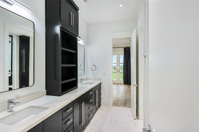 2425 E Seaside Dr, Galveston, TX 77550 - bathroom with double vanity, marble tiled flooring, ornamental molding, and recessed lighting