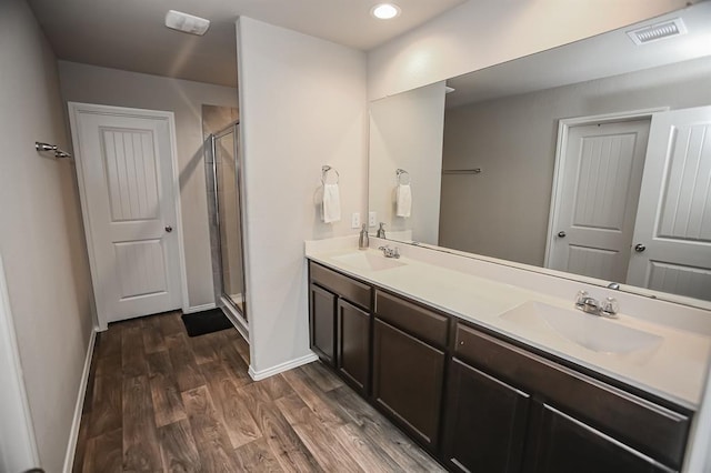 919 Bright Lotus Ln, Rosharon, TX 77583 - full bathroom featuring a stall shower, double vanity, wood finished floors, and recessed lighting