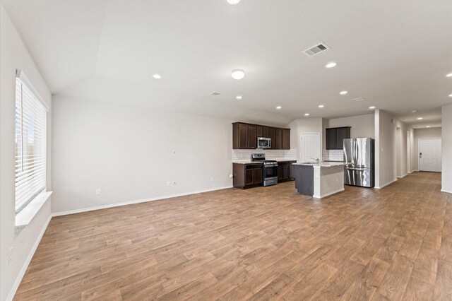 919 Bright Lotus Ln, Rosharon, TX 77583 - unfurnished living room featuring light wood-type flooring and recessed lighting
