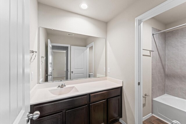 919 Bright Lotus Ln, Rosharon, TX 77583 - bathroom featuring vanity, tub / shower combination, and wood finished floors