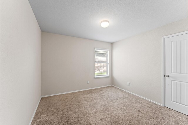 919 Bright Lotus Ln, Rosharon, TX 77583 - carpeted spare room with baseboards and a textured ceiling