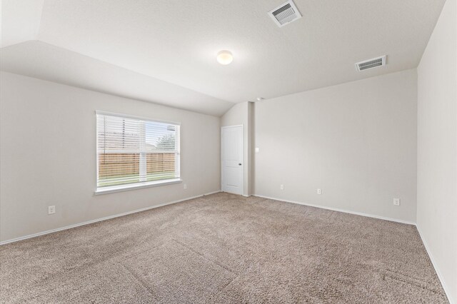 919 Bright Lotus Ln, Rosharon, TX 77583 - carpeted empty room featuring lofted ceiling and baseboards