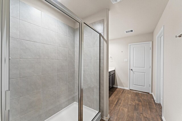 919 Bright Lotus Ln, Rosharon, TX 77583 - bathroom featuring a shower stall, vanity, and wood finished floors