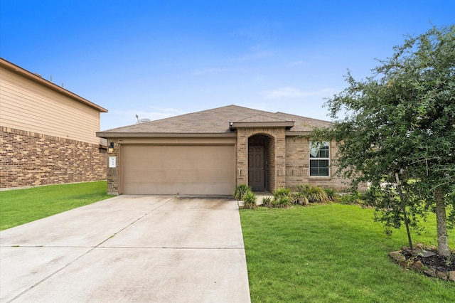 919 Bright Lotus Ln, Rosharon, TX 77583 - view of front of home with an attached garage, driveway, a front yard, and brick siding