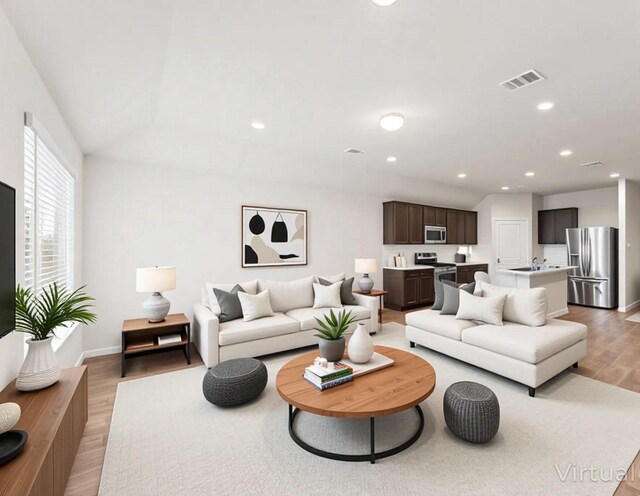 919 Bright Lotus Ln, Rosharon, TX 77583 - living area featuring light wood-type flooring, recessed lighting, and lofted ceiling