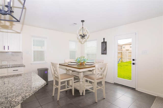 4523 Lally Brook Ct, Katy, TX 77493 - dining space featuring a chandelier, plenty of natural light, and dark tile patterned flooring