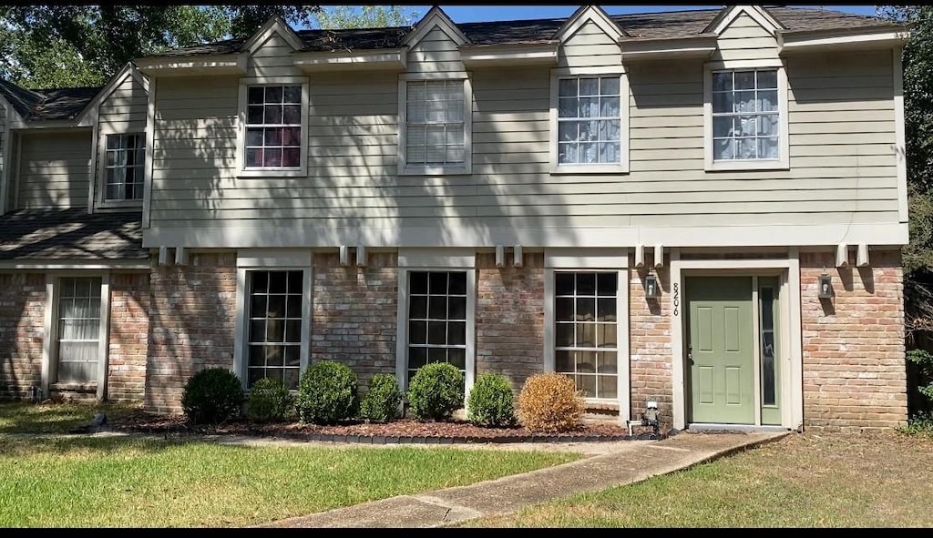 8206 Ash Valley Dr, Spring, TX 77379 - view of front of home with brick siding and a front lawn