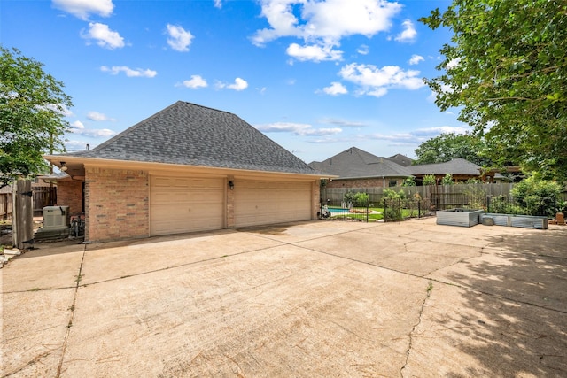19011 Oakway Dr, Spring, TX 77388 - view of home's exterior featuring brick siding, a shingled roof, and concrete driveway