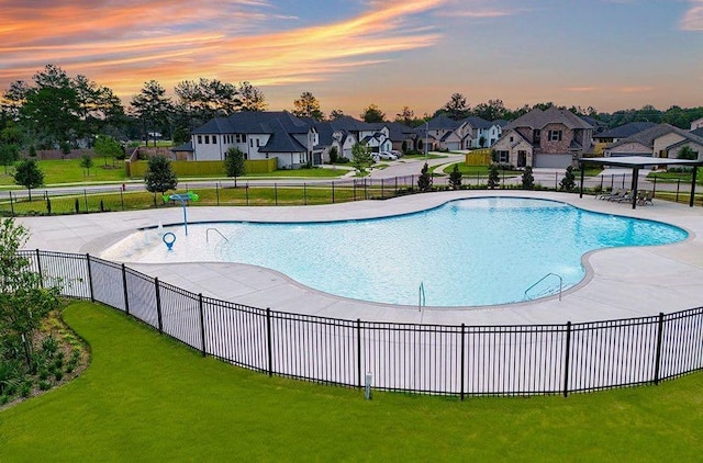 1235 Buffalo Run, Tomball, TX 77375 - pool at dusk featuring a residential view and a patio