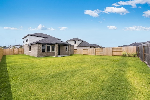 1235 Buffalo Run, Tomball, TX 77375 - rear view of house with a fenced backyard, brick siding, and a patio