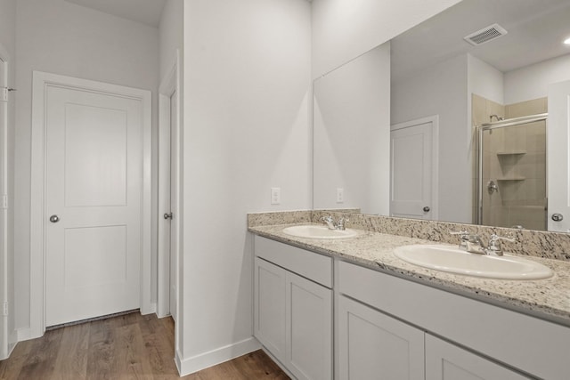 105 Bayou Bend Ct, Angleton, TX 77515 - full bath with a shower stall, double vanity, and wood finished floors