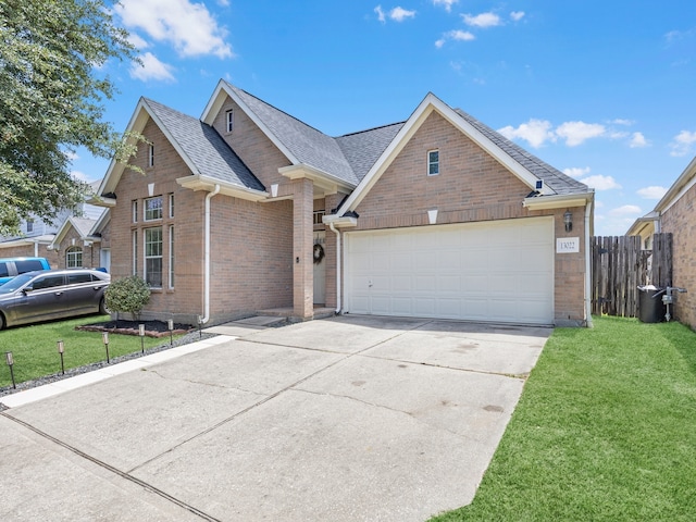 13022 Echo Landing Dr, Houston, TX 77070 - view of front of house with brick siding, driveway, a shingled roof, and a garage