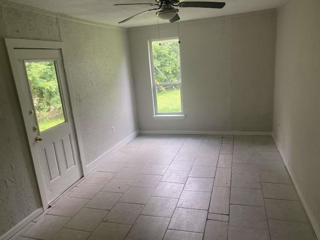 15626 Corsair Rd, Houston, TX 77053 - empty room featuring a ceiling fan, light tile patterned flooring, and a textured wall