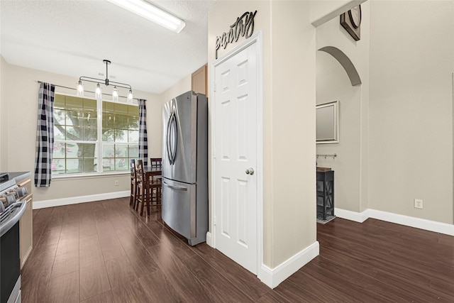 20014 Coyote Ridge Ln, Katy, TX 77449 - kitchen with stainless steel appliances, dark wood-style floors, and a textured ceiling
