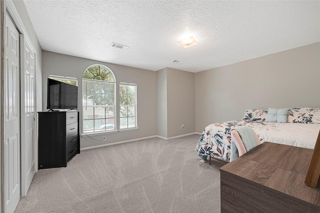 20014 Coyote Ridge Ln, Katy, TX 77449 - bedroom with light carpet, a textured ceiling, and a closet