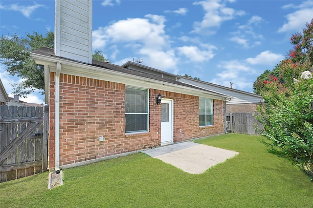 20014 Coyote Ridge Ln, Katy, TX 77449 - back of house with a chimney, brick siding, and a patio