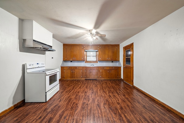 523 Main St, La Marque, TX 77568 - kitchen featuring white range with electric cooktop, brown cabinetry, dark wood-type flooring, a ceiling fan, and light countertops