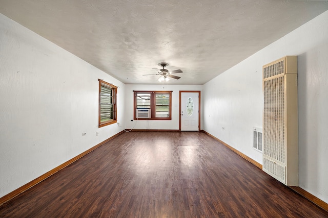 523 Main St, La Marque, TX 77568 - spare room with a heating unit, wood finished floors, cooling unit, ceiling fan, and a textured ceiling