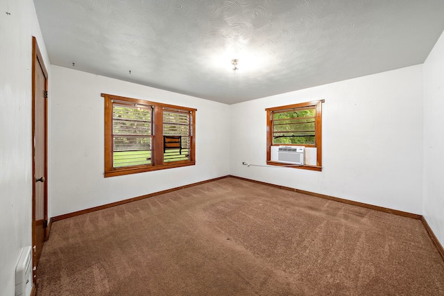 523 Main St, La Marque, TX 77568 - spare room featuring healthy amount of natural light, carpet, cooling unit, and a baseboard radiator