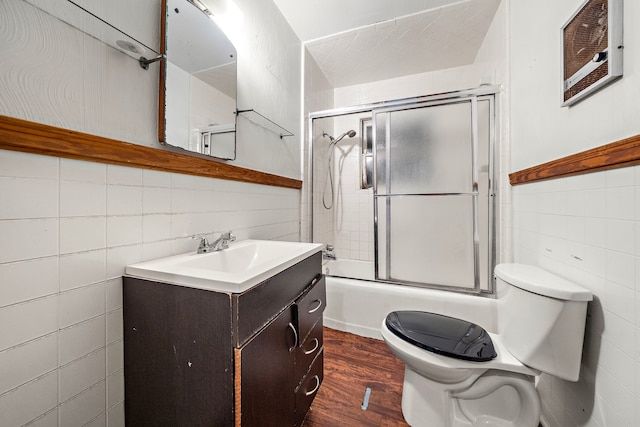 523 Main St, La Marque, TX 77568 - full bathroom featuring vanity, tile walls, bath / shower combo with glass door, and wood finished floors