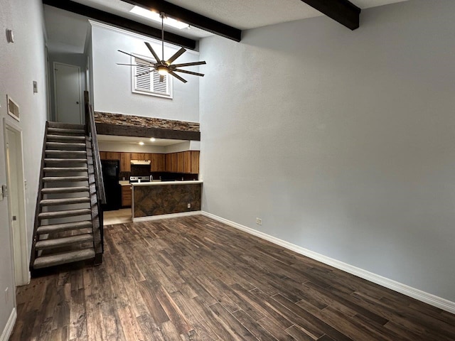 2510 Grants Lake Blvd Unit 101, Sugar Land, TX 77479 - unfurnished living room featuring beamed ceiling, a ceiling fan, dark wood-type flooring, and stairs