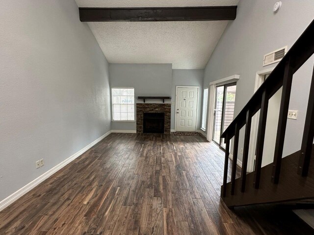 2510 Grants Lake Blvd Unit 101, Sugar Land, TX 77479 - unfurnished living room with dark wood-style flooring, a fireplace, and a textured ceiling