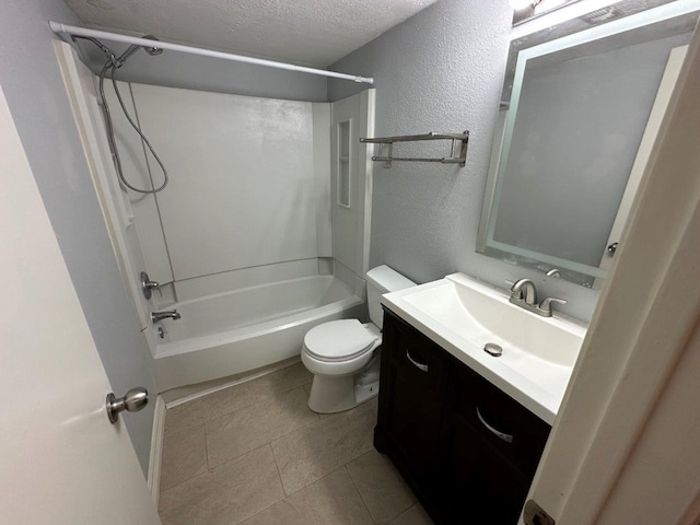 2510 Grants Lake Blvd Unit 101, Sugar Land, TX 77479 - full bath with a textured wall, vanity,  shower combination, a textured ceiling, and tile patterned flooring